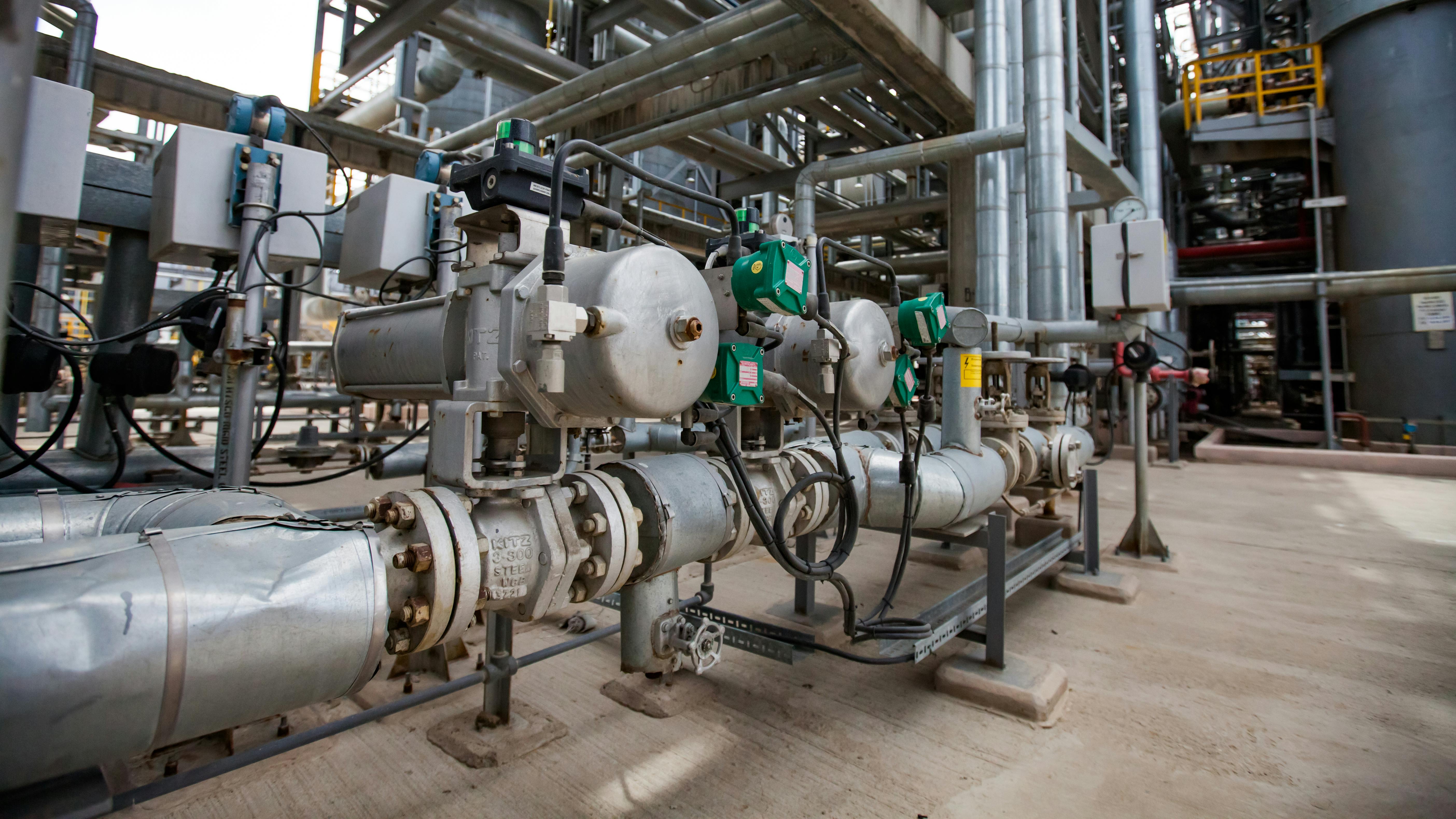 Oil refinery plant. Close up of equipment. Pipes in background.