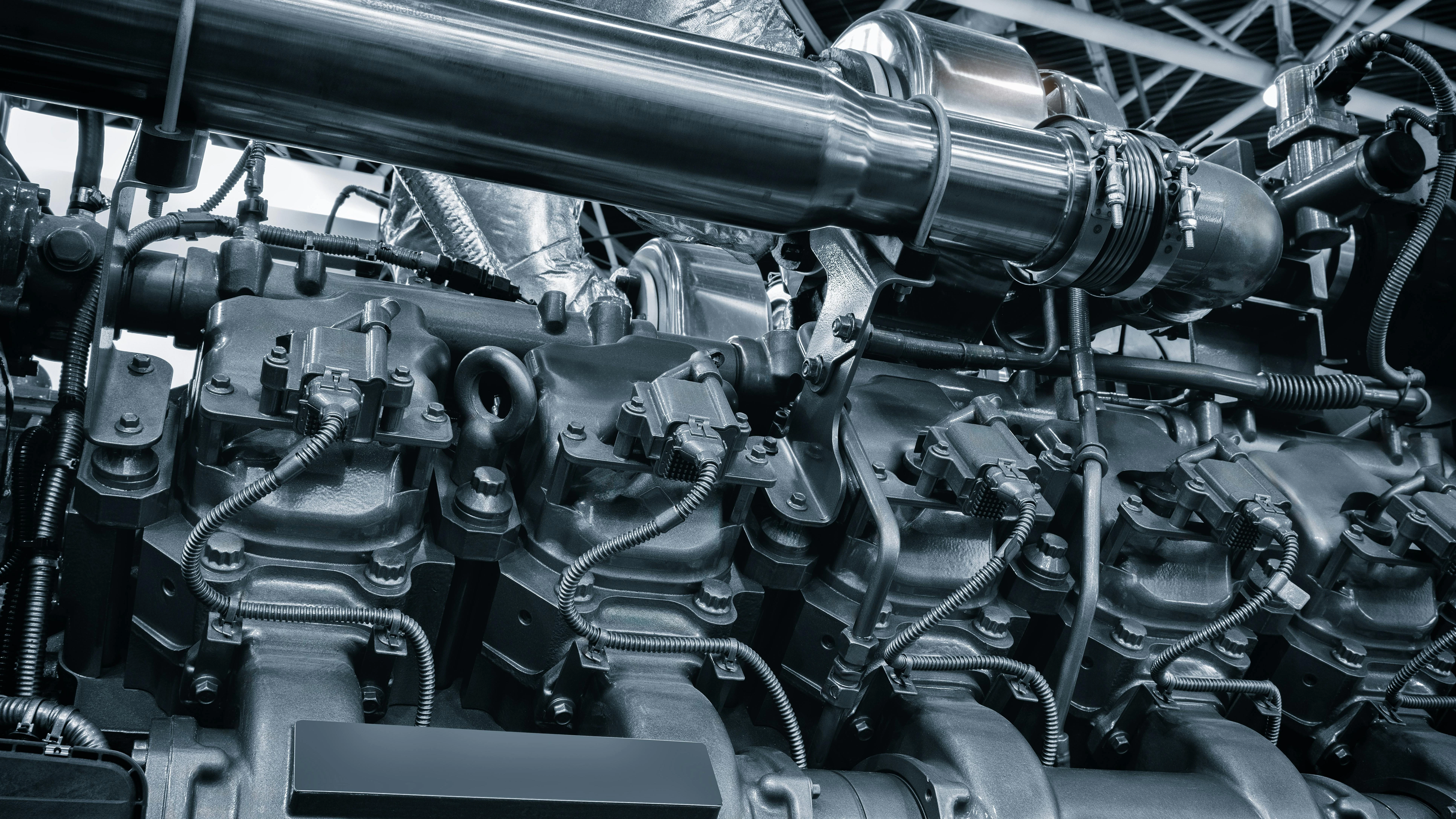 black and white photo of large industrial diesel engine