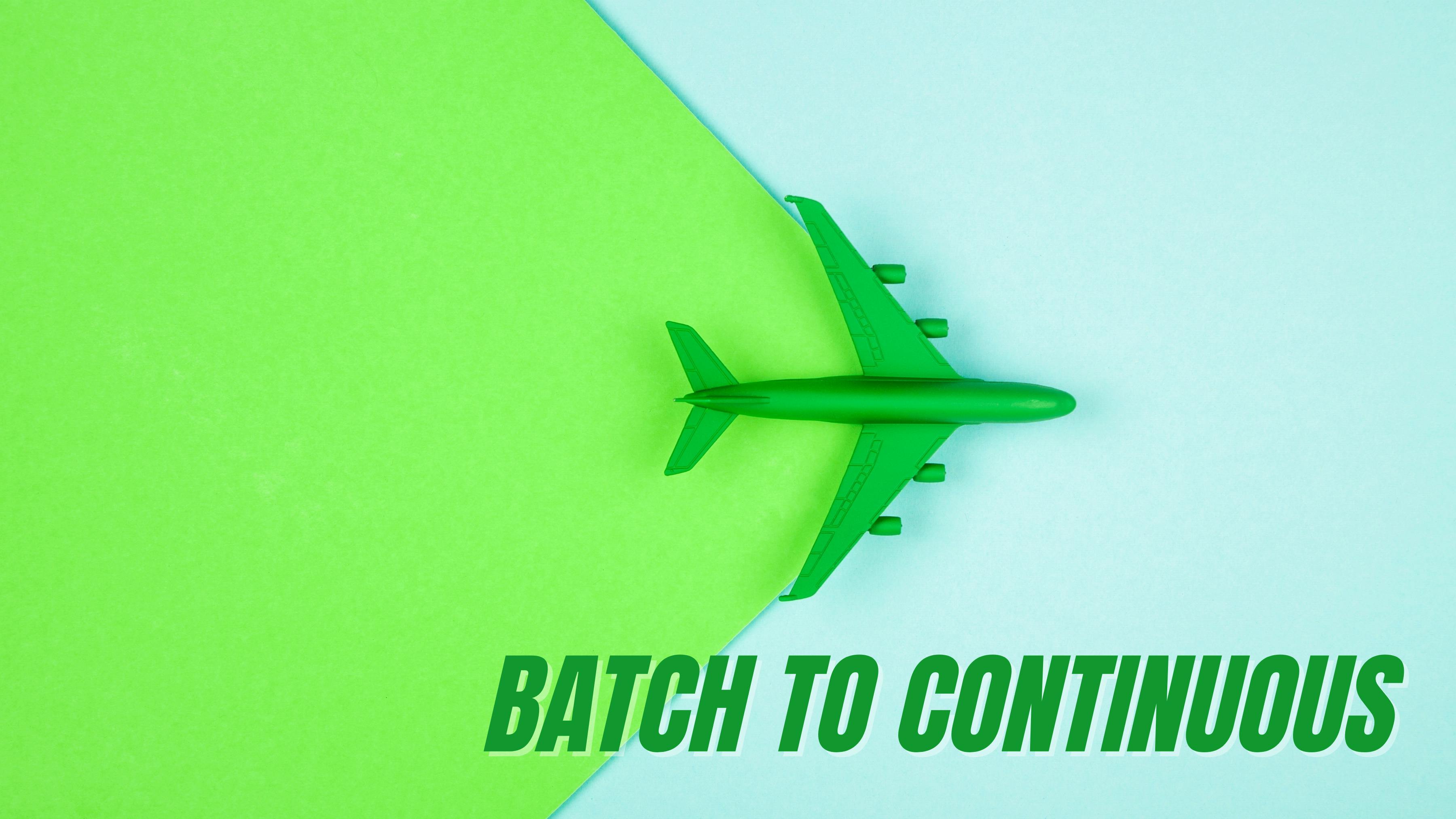 plane in blue sky with green background trailing behind for sustainable aviation fuel and batch to continuous concept