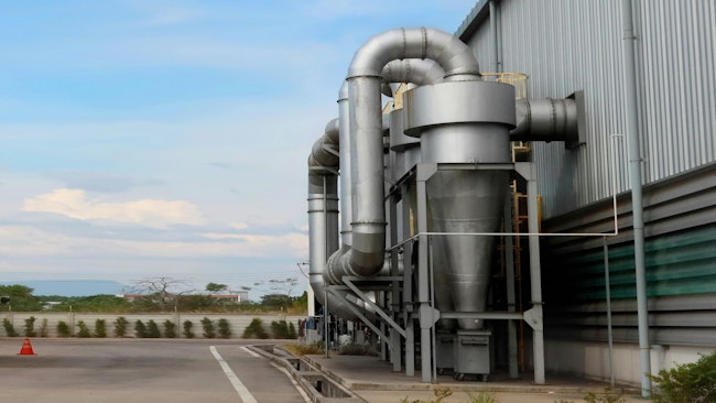 Air pollution control equipment as dust cyclone collection and chimney stack locates out of industrial building.