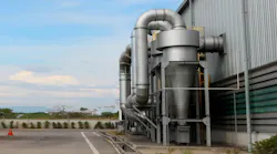 Air pollution control equipment as dust cyclone collection and chimney stack locates out of industrial building.