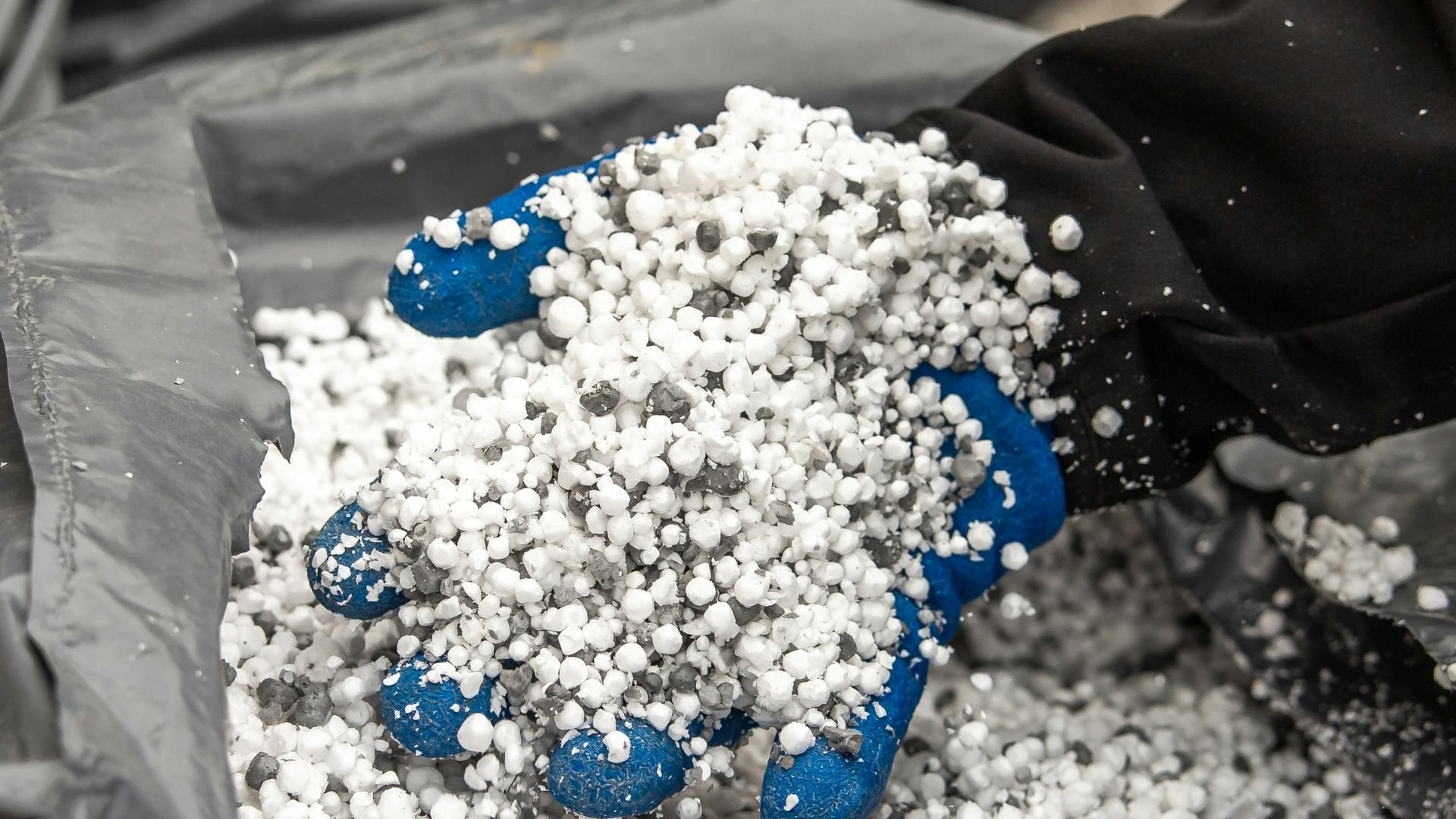 gloved hand holds sticky solids