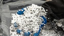 gloved hand holds sticky solids gloved hand holds sticky solids