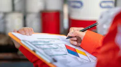 worker checking off safety protocols on clipboard