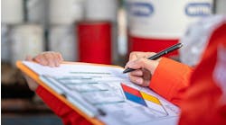 chemical plant safety. worker checking off safety protocols. chemical plant safety. worker checking off safety protocols.