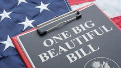 clipboard with paper reading 'One Big Beautiful Bill' sits atop American flag clipboard with paper reading 'One Big Beautiful Bill' sits atop American flag