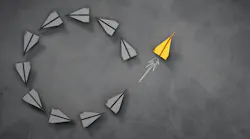 paper airplanes form a circle shape with one flying away from it