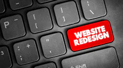 where the enter button sits on a keyboard a red website redesign button is surrounded by all other keys in black.