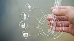 hand holds test tube filled with clear liquid and microplastics hand holds test tube filled with clear liquid and microplastics