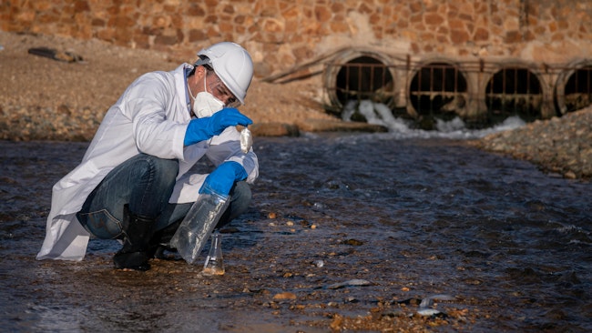 Scientist conducts air and water quality research along riverbed