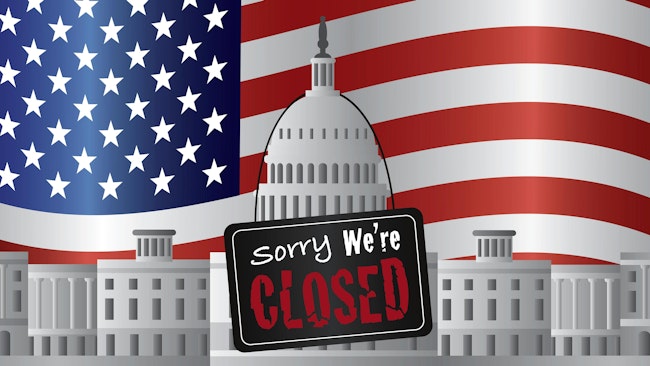 US government building with a Sorry we're closed sign and US flag in background