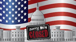 US government building with a Sorry we're closed sign and US flag in background US government building with a Sorry we're closed sign and US flag in background