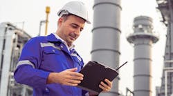 Male industrial worker in hard hat with tablet Male industrial worker in hard hat with tablet