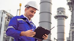 Male industrial worker in hard hat with tablet Male industrial worker in hard hat with tablet