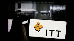 Person holding mobile phone with logo of American industrial manufacturing company ITT Inc. on screen in front of web page. Focus on phone display. Unmodified photo. Person holding mobile phone with logo of American industrial manufacturing company ITT Inc. on screen in front of web page. Focus on phone display. Unmodified photo.