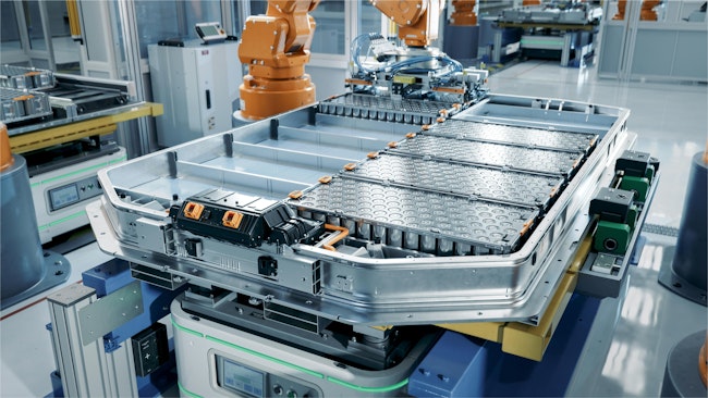 EV Battery Pack on Production Line Equipped with Robot Arms inside Modern Factory