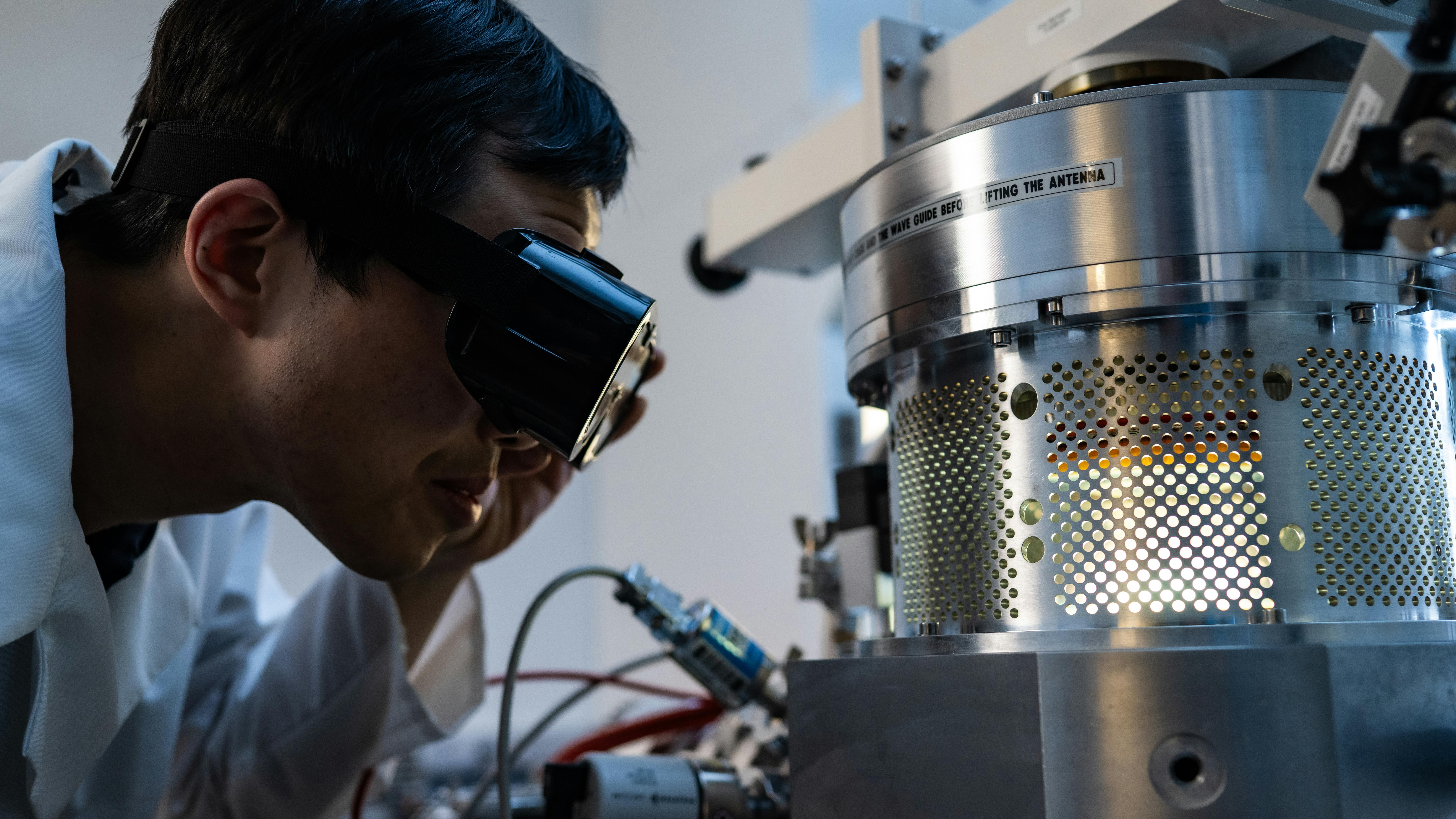 Xiang Zhang with the microwave plasma chemical vapor deposition setup. (Photo by Jeff Fitlow/Rice University)