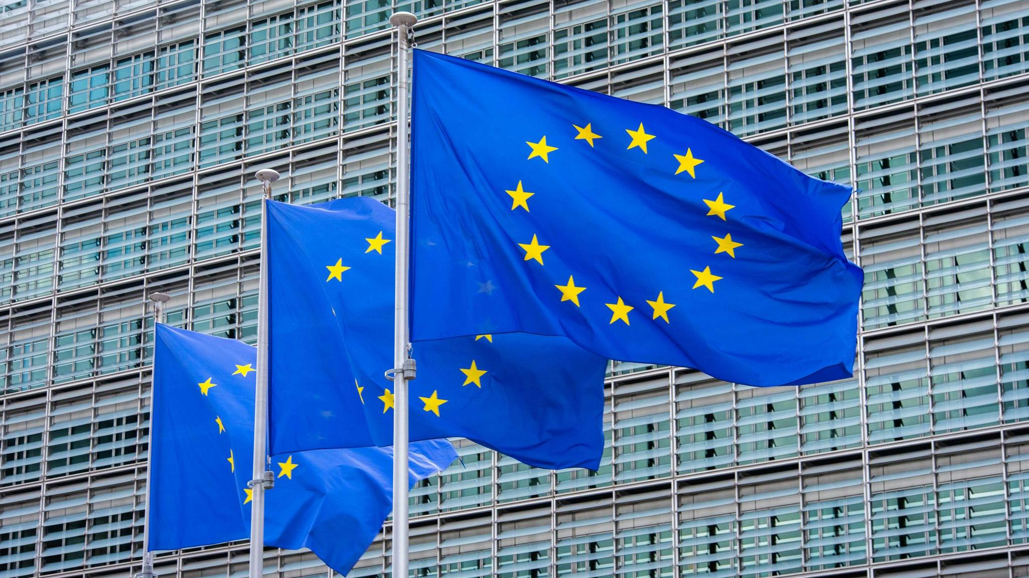 Three flags of the European Union fly in front of the Berlaymont building in Brussels, the seat of the European Commission. (Alicia Windzio/dpa/TNS)