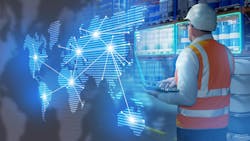 Warehouseman stands in warehouse with barrels. International logistics supply chains. Man logistician holding laptop with his back to camera. Warehouseman stands in warehouse with barrels. International logistics supply chains. Man logistician holding laptop with his back to camera.