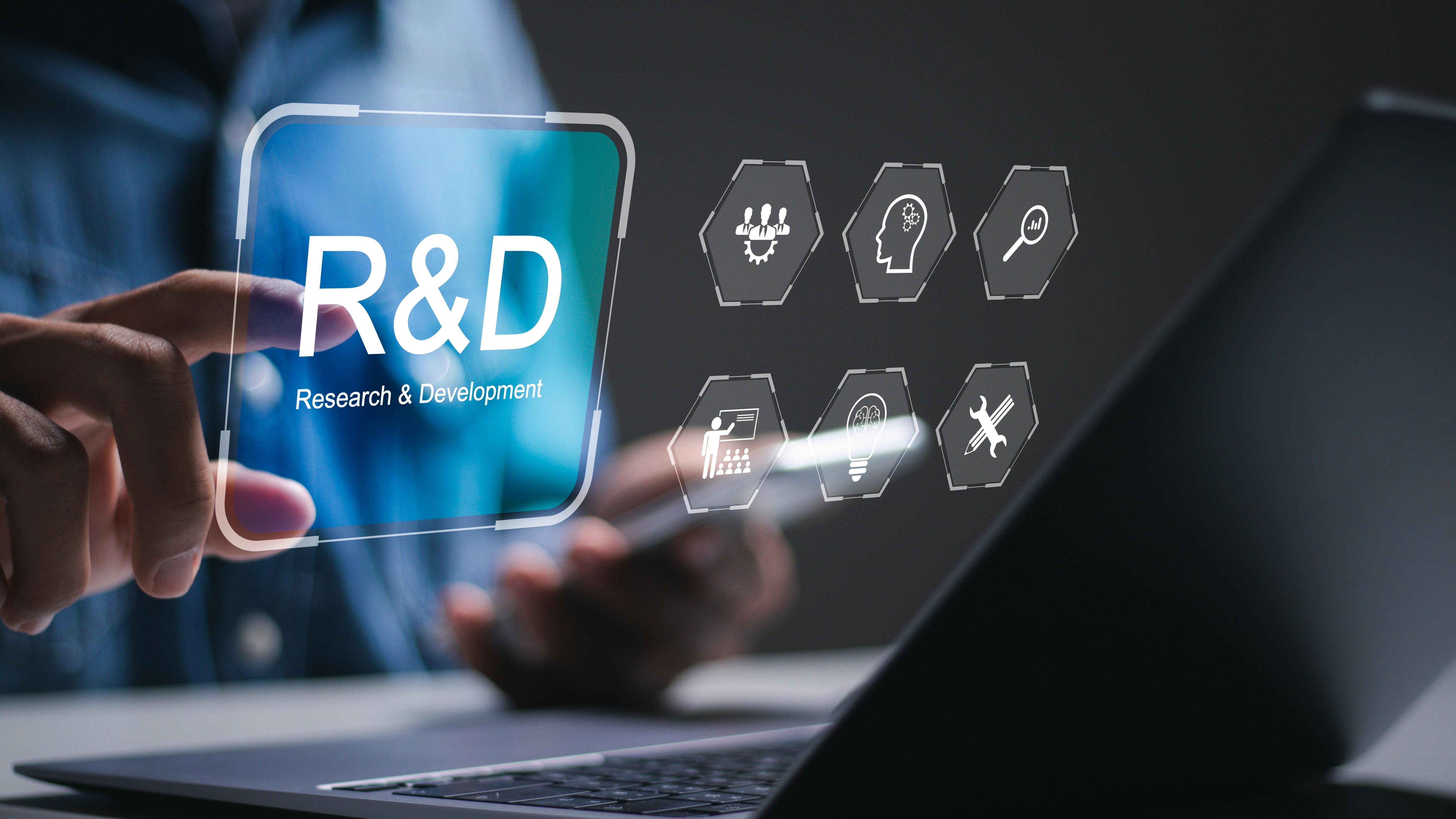 R and D, Research and Development concept. businessman use laptop with virtual R and D icons for research and development of business science technology.