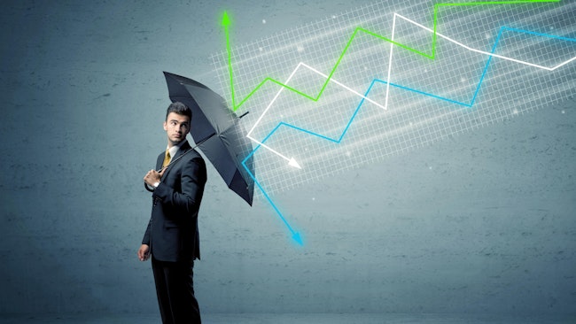 man in suit holding umbrella with economic line graphs 'falling' onto and bouncing off umbrella