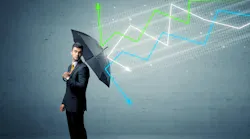 man in suit holding umbrella with economic line graphs 'falling' onto and bouncing off umbrella man in suit holding umbrella with economic line graphs 'falling' onto and bouncing off umbrella