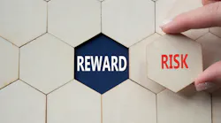 hand holds a hexagonal tile with the word risk. in the background hexagonal tiles surround empty slot that reveals the word reward hand holds a hexagonal tile with the word risk. in the background hexagonal tiles surround empty slot that reveals the word reward
