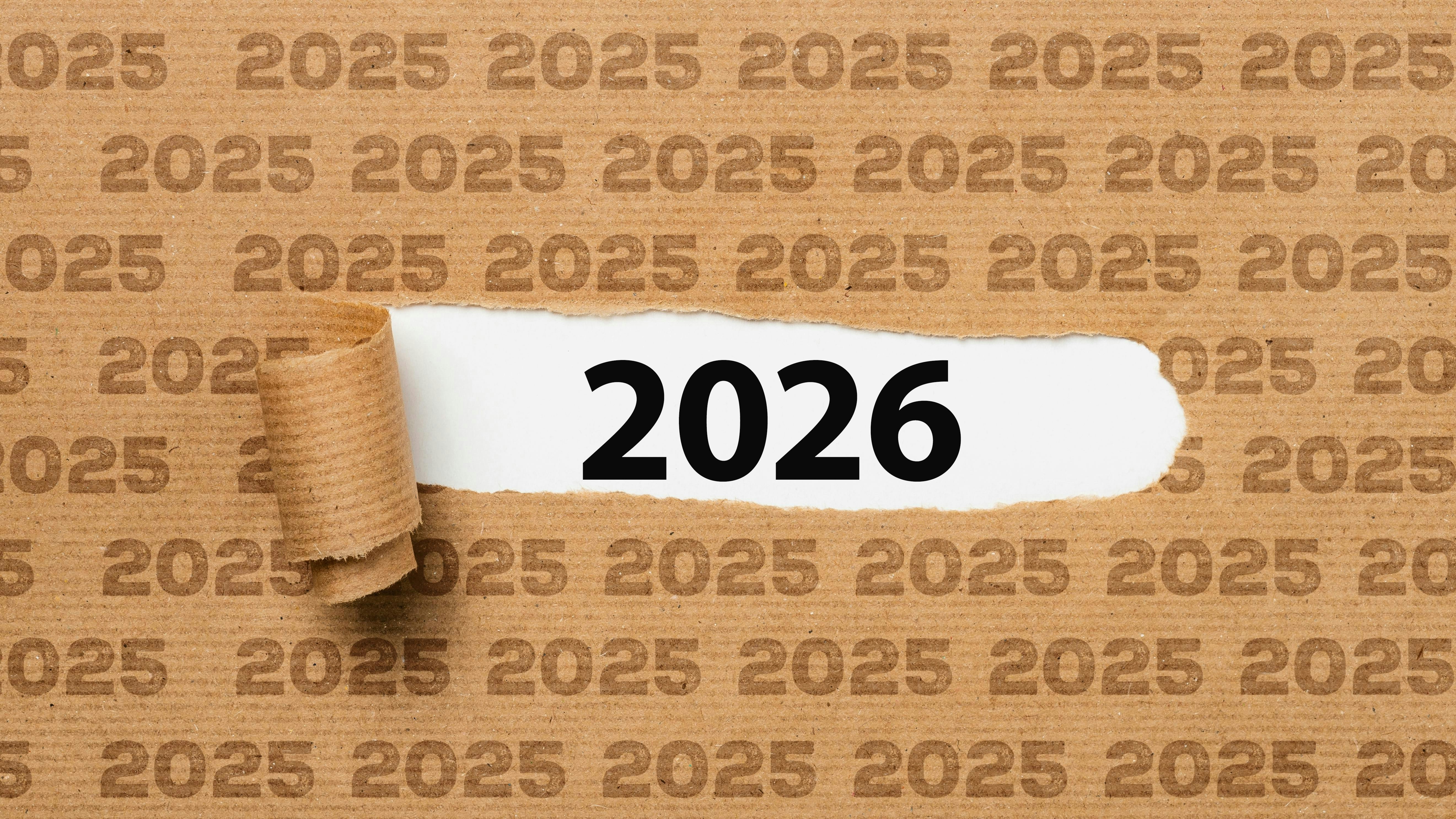 Paper with text 2025 ripped to show 2026 underneath it