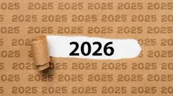 Paper with text 2025 ripped to show 2026 underneath it
