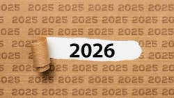 Paper with text 2025 ripped to show 2026 underneath it Paper with text 2025 ripped to show 2026 underneath it