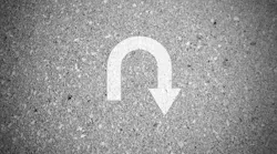 White u turn sign on asphalt concret street as background