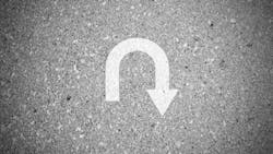 White u turn sign on asphalt concret street as background White u turn sign on asphalt concret street as background