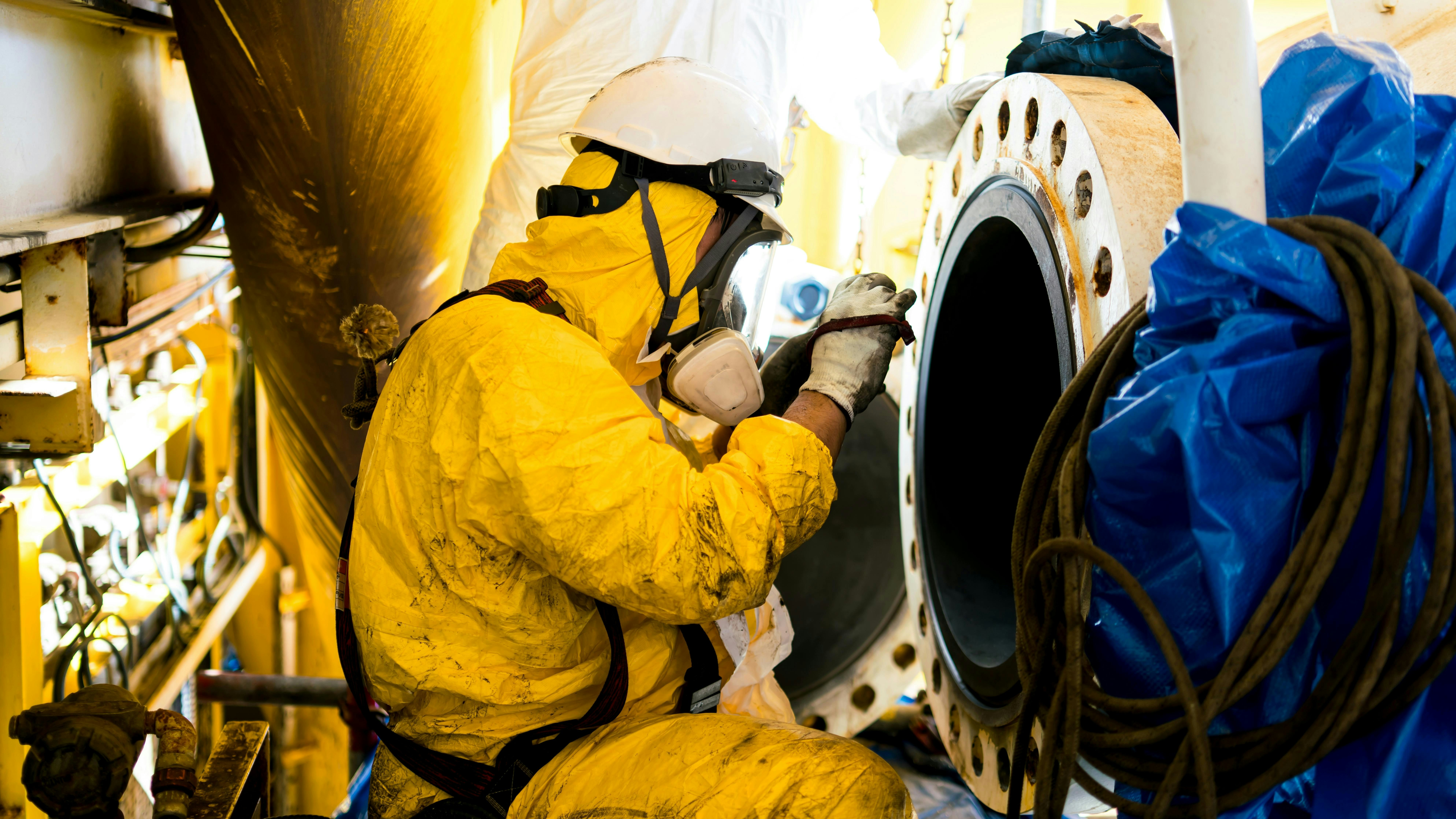 Employees inspect by taking photographs of internal pressure tanks in confined spaces.