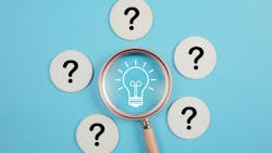 magnifying glass over image of light bulb surrounded by five question marks magnifying glass over image of light bulb surrounded by five question marks