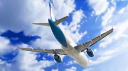 Overhead view of airplane with blue sky and clouds in backgrond