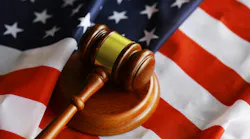 overhead shot of judge's gavel sitting on top of US flag