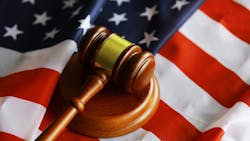 overhead shot of judge's gavel sitting on top of US flag overhead shot of judge's gavel sitting on top of US flag