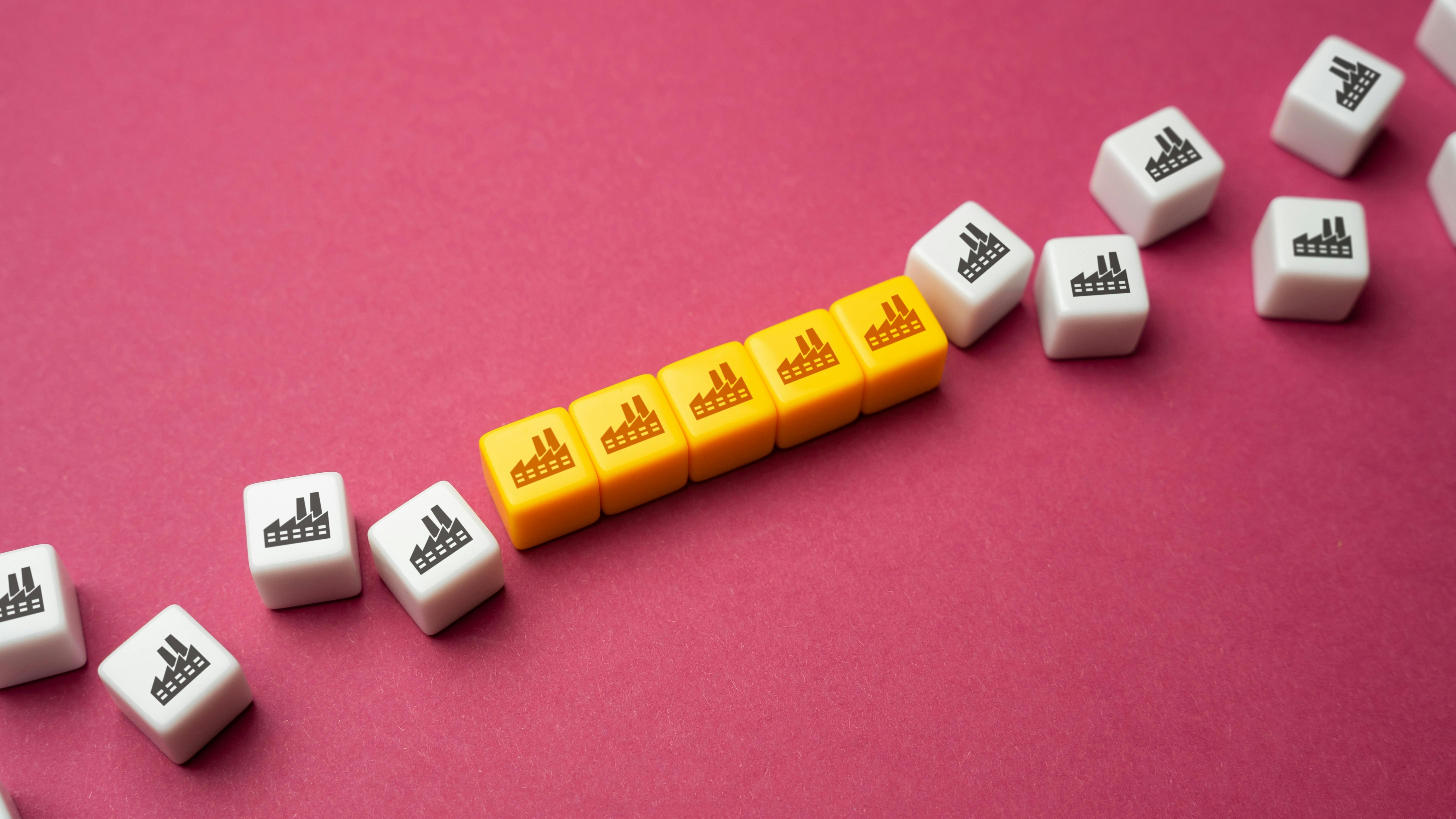 blocks with factory icon combined together to represent consolidation