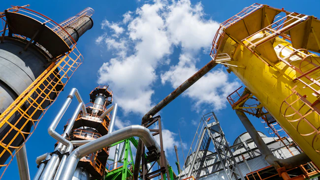 Chemical plant tower with pipes vertical view looking up at sky