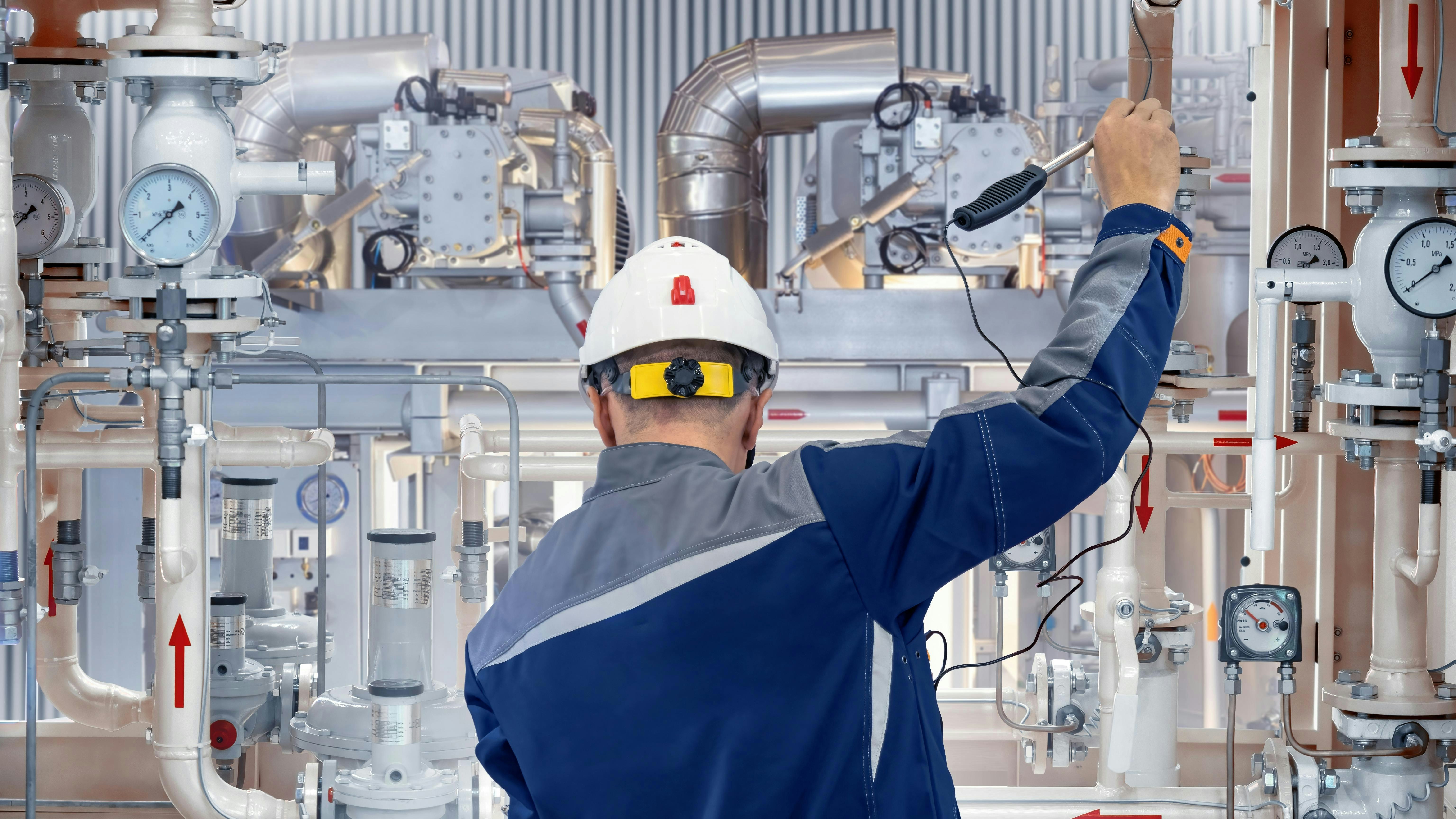 industrial worker tests control valves