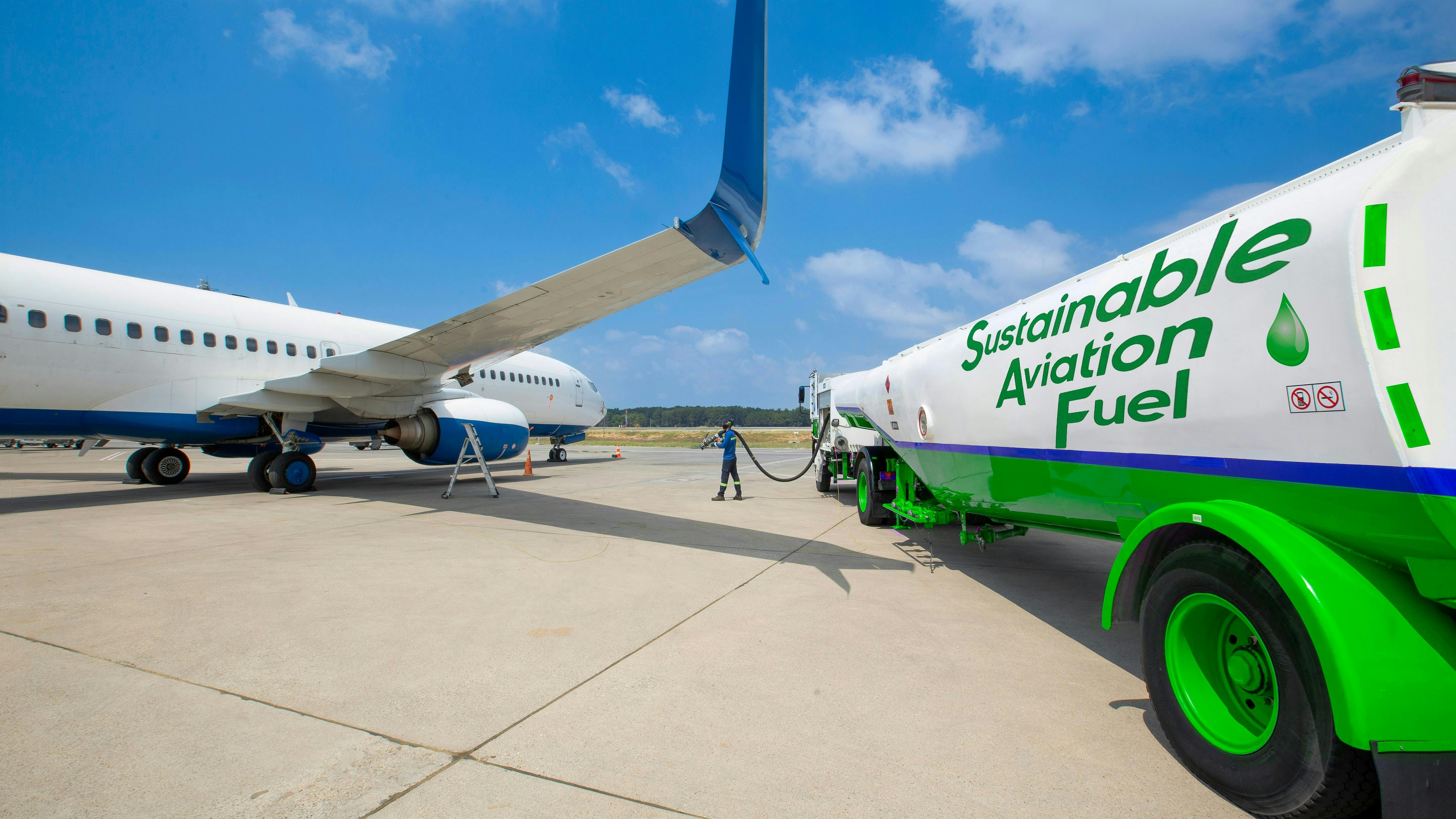 Sustainable Aviation Fuel (SAF). Technician refueling private jet with SAF at the airport.
