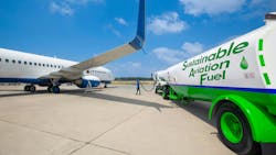 Sustainable Aviation Fuel (SAF). Technician refueling private jet with SAF at the airport. Sustainable Aviation Fuel (SAF). Technician refueling private jet with SAF at the airport.