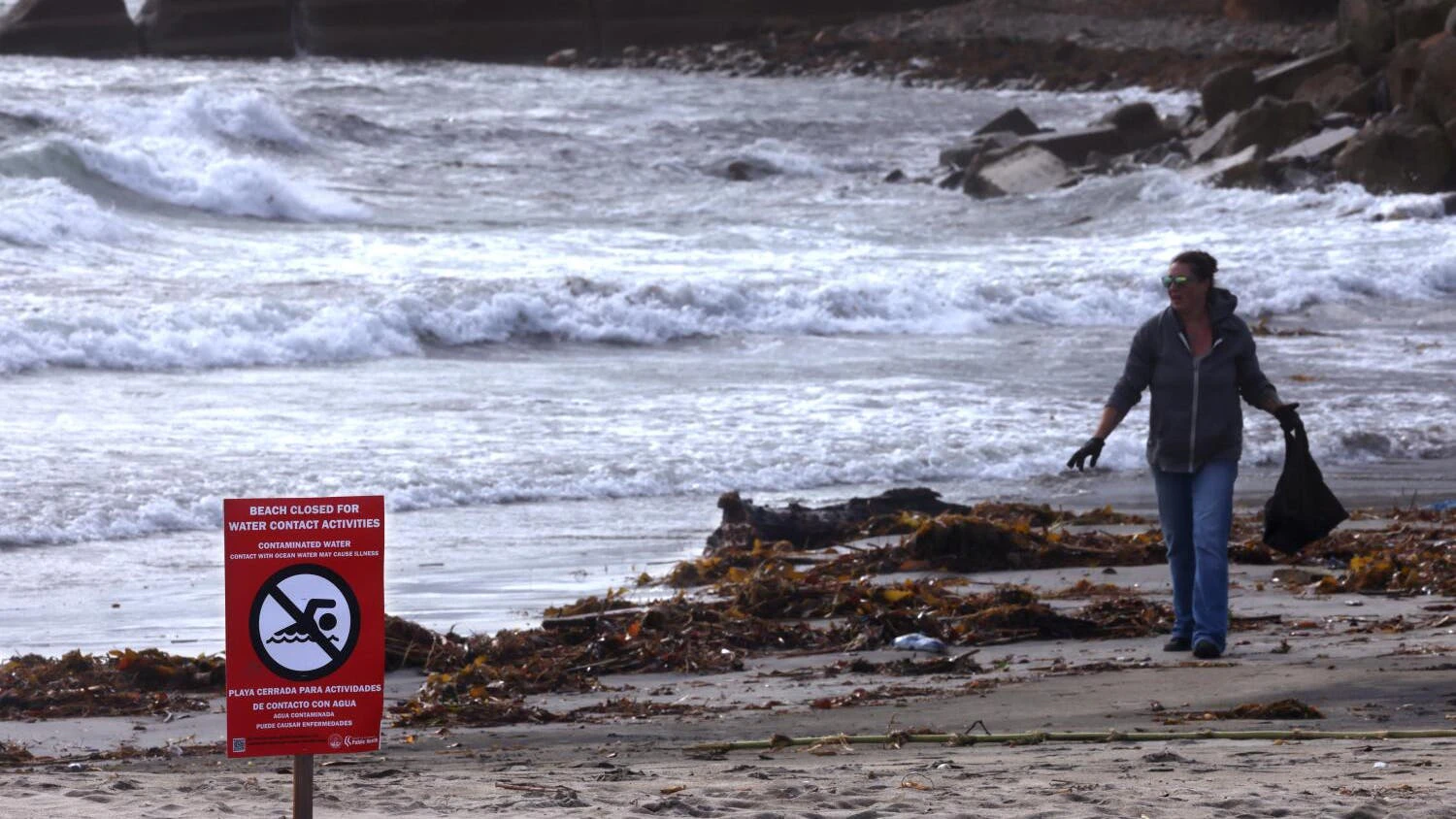 Crystal Schalmo, founder of Green Dragon Conservation Education, collects garbage and other debris that washed up after a storm on Cabrillo Beach in the Los Angeles neighborhood of San Pedro on Dec. 25, 2025. (Genaro Molina/Los Angeles Times/TNS)