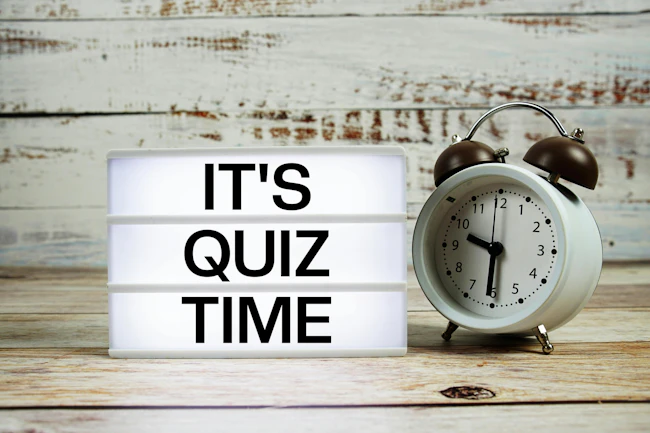 It's Quiz Time marquee with an alarm clock to introduce a trivia quiz for chemical engineers