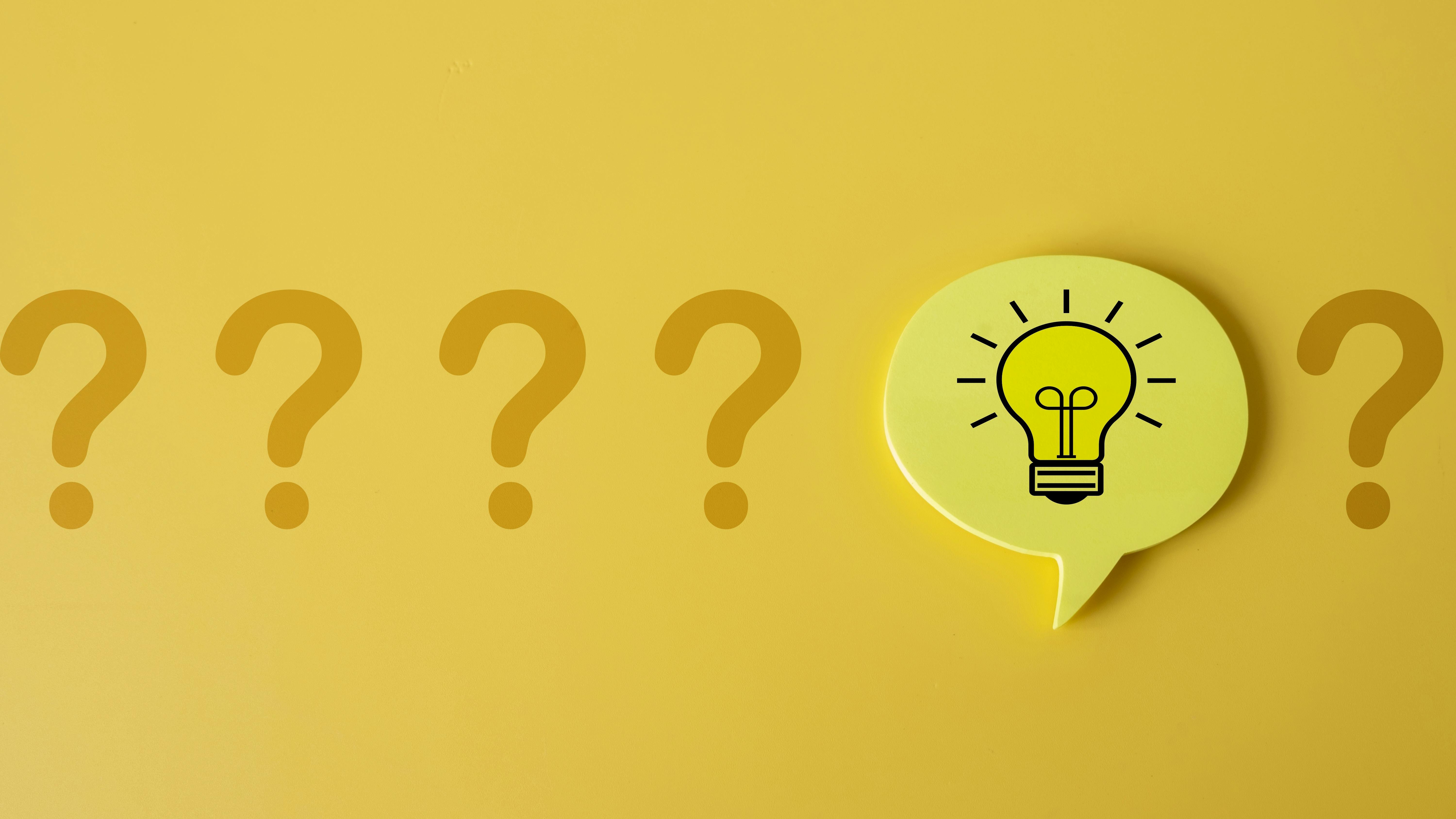 Row of five question marks with an idea lightbulb speech bubble placed before the fifth question mark.