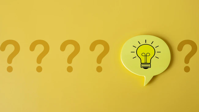 Row of five question marks with an idea lightbulb speech bubble placed before the fifth question mark.