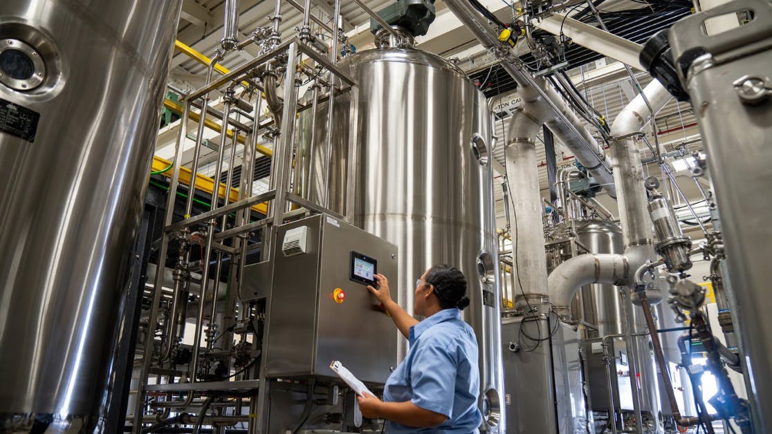Worker examines control panel at Locus Fermentation Solutions