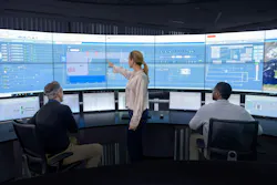 Workers in control room with computer screens displaying ABB Symphony Plus Distributed Control System Workers in control room with computer screens displaying ABB Symphony Plus Distributed Control System