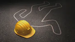 chalk body outline and hard hat on asphalt
