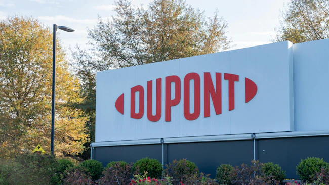 DuPont sign displayed at headquarters with bushes and trees in the background.